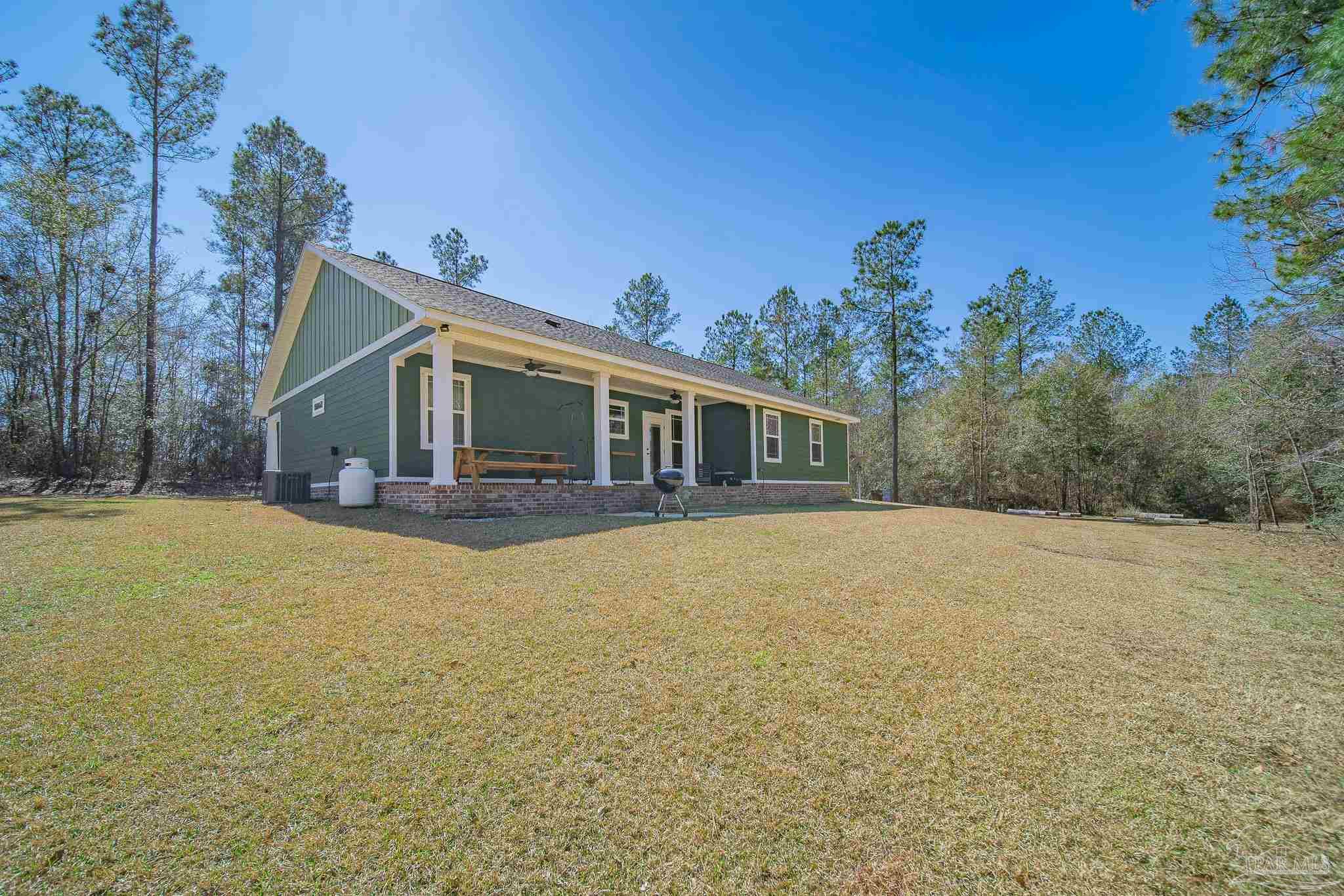 2800 Dunsford Road Jay, FL 32565 - Photo 30 of 42 a front view of house with yard and trees in the background
