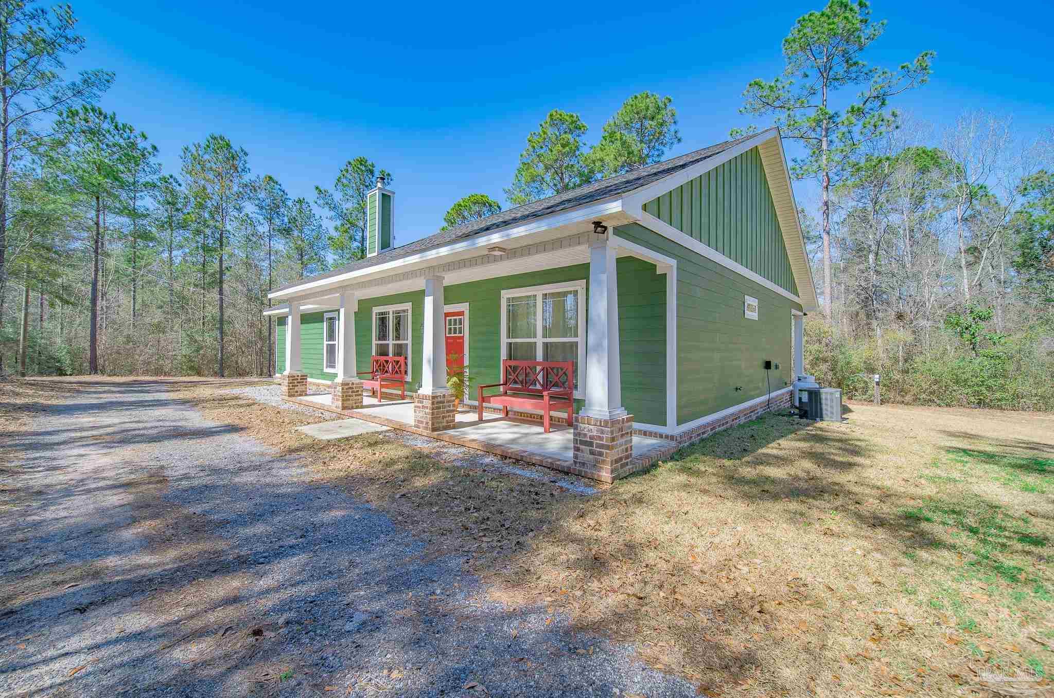 2800 Dunsford Road Jay, FL 32565 - Photo 3 of 42 a view of a house with a yard and potted plants