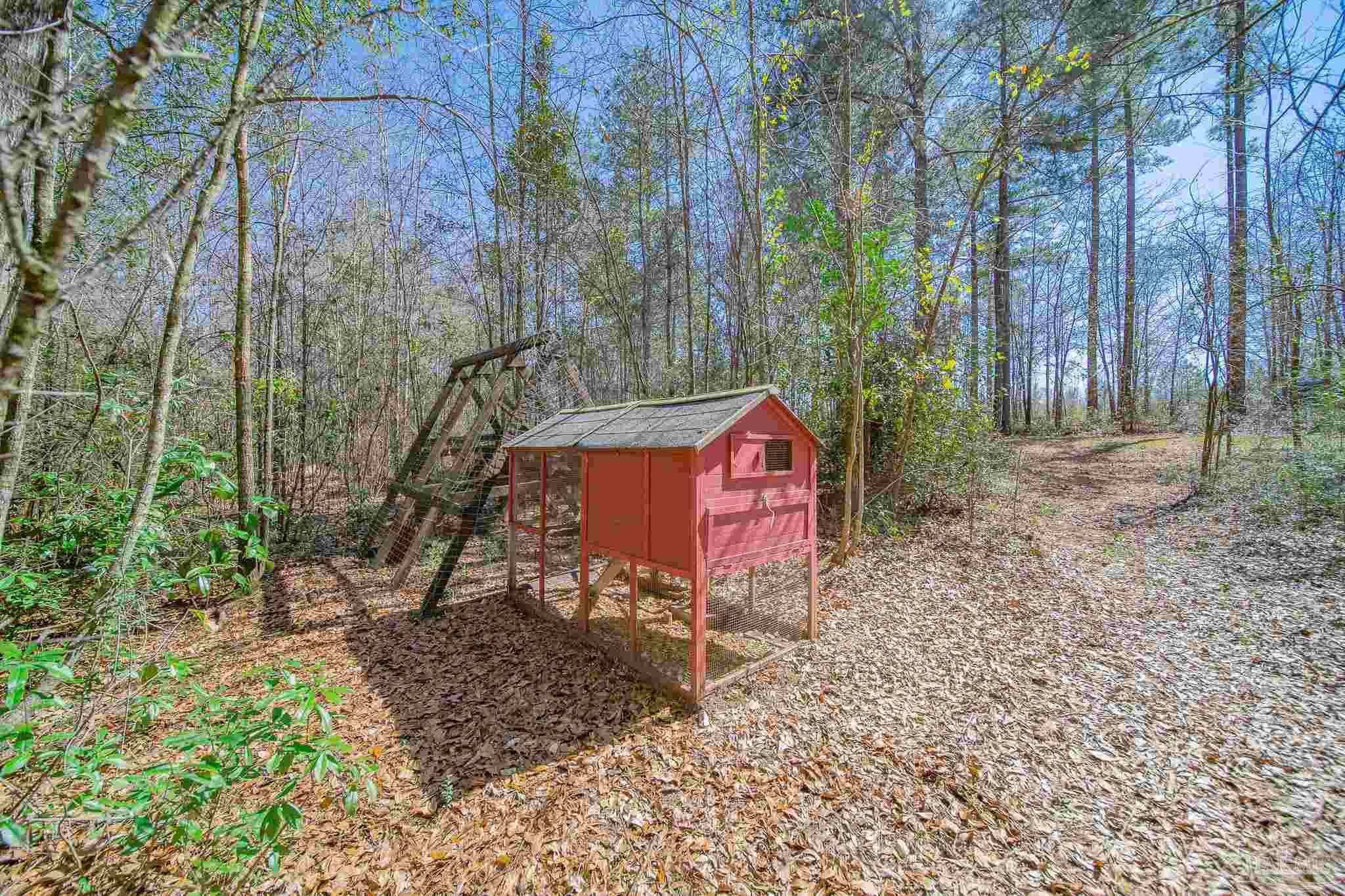 2800 Dunsford Road Jay, FL 32565 - Photo 34 of 42 a sign that is sitting in front of a forest