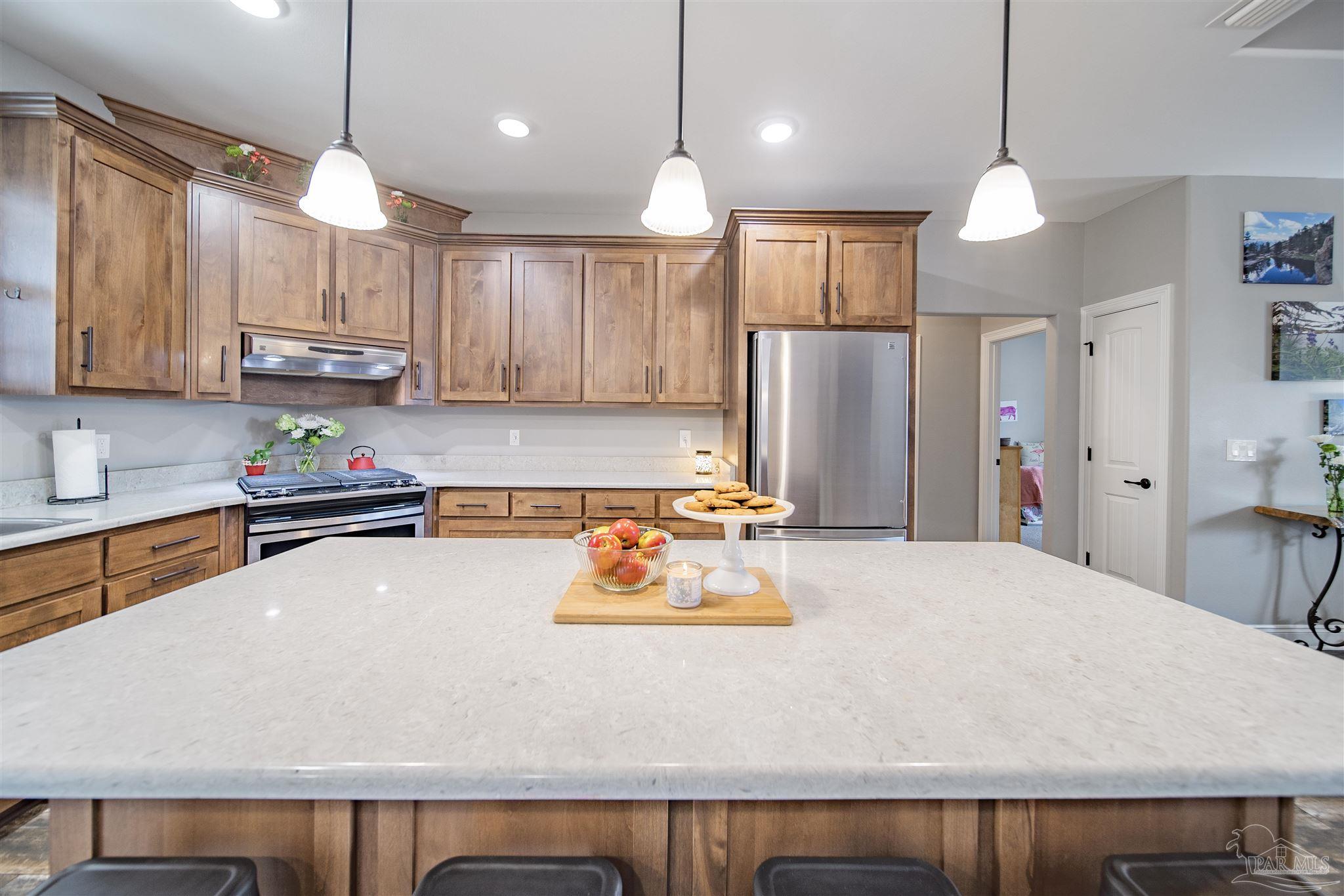 2800 Dunsford Road Jay, FL 32565 - Photo 9 of 42 a kitchen with a refrigerator a sink and wooden floor