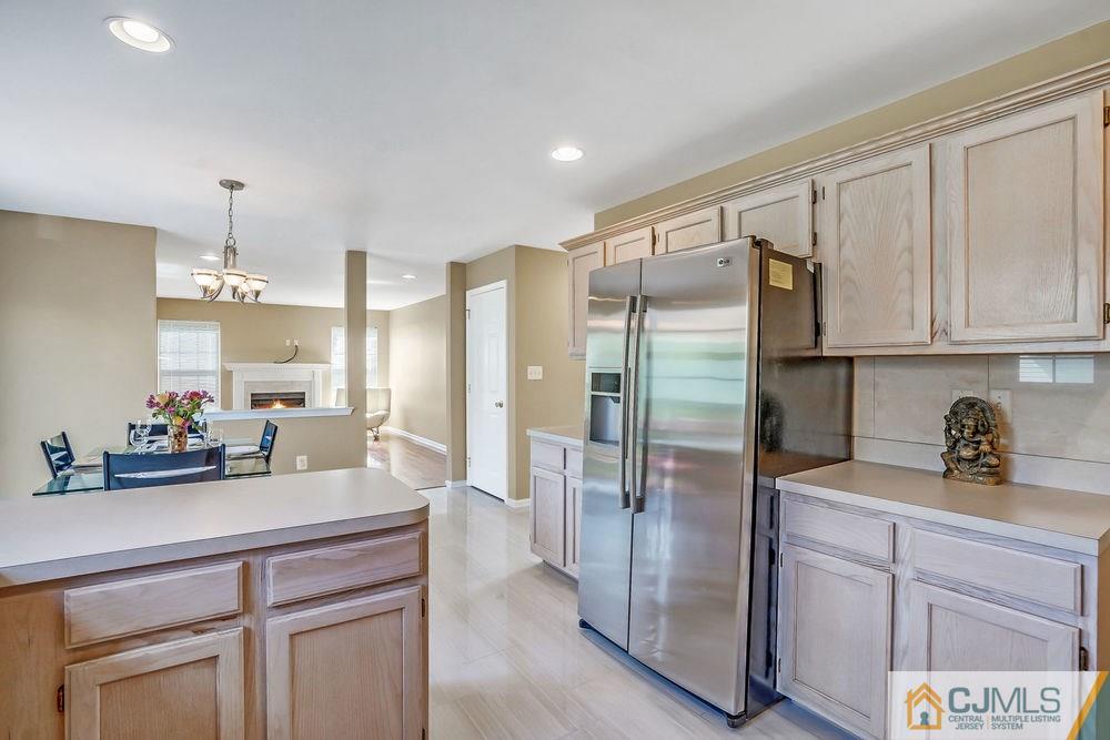23 Mapleton Road Old Bridge, NJ 08857 - Photo 11 of 24 a kitchen with stainless steel appliances a refrigerator sink and cabinets
