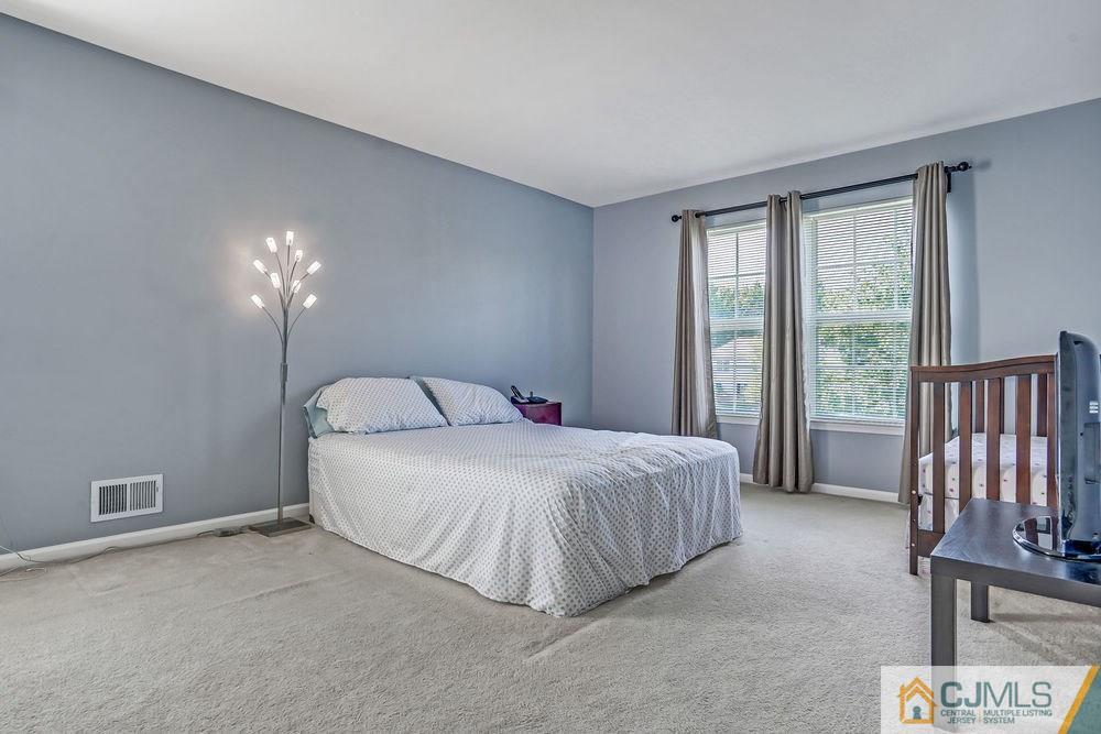 23 Mapleton Road Old Bridge, NJ 08857 - Photo 14 of 24 a bedroom with a bed and a lamp with window