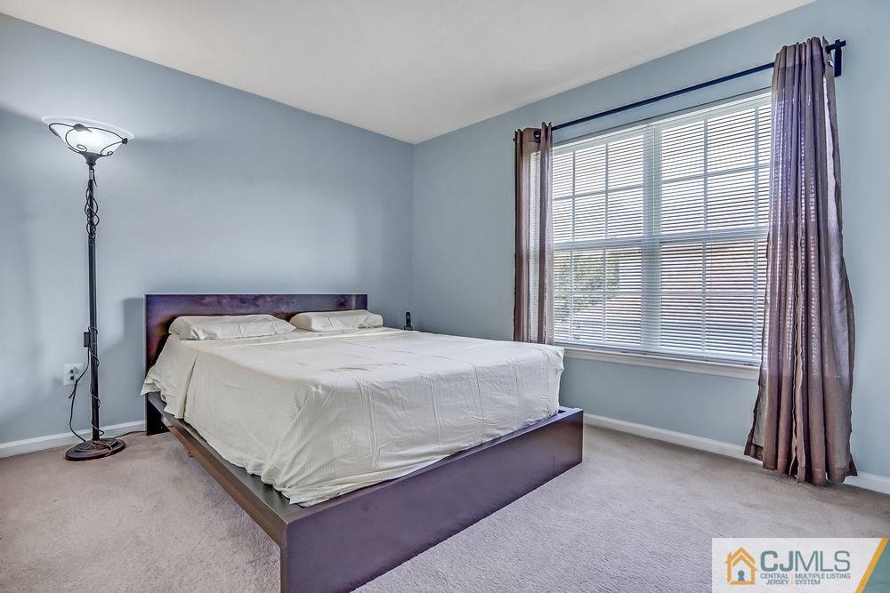 23 Mapleton Road Old Bridge, NJ 08857 - Photo 15 of 24 a bed sitting in a bedroom next to a window