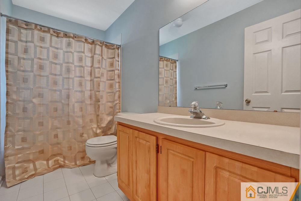 23 Mapleton Road Old Bridge, NJ 08857 - Photo 16 of 24 a bathroom with a granite countertop sink a toilet and a mirror