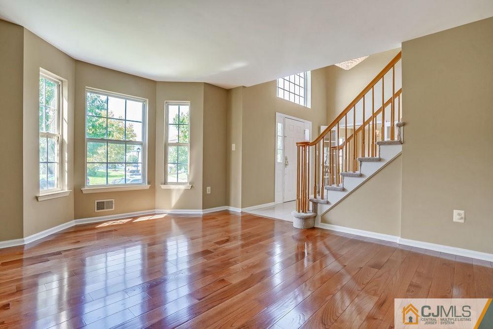 23 Mapleton Road Old Bridge, NJ 08857 - Photo 6 of 24 a view of an entryway with wooden floor and windows
