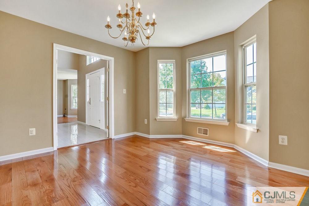 23 Mapleton Road Old Bridge, NJ 08857 - Photo 8 of 24 a view of an empty room with wooden floor and a window