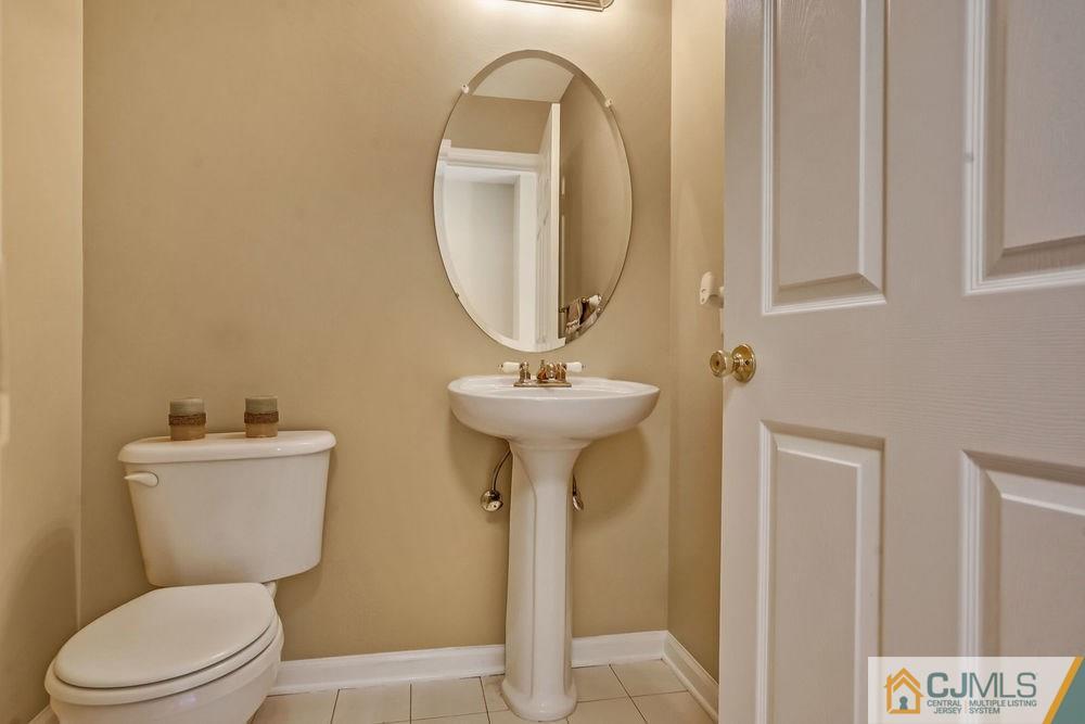 23 Mapleton Road Old Bridge, NJ 08857 - Photo 9 of 24 a bathroom with a toilet a sink and a mirror