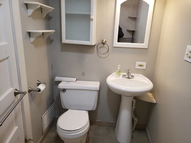 a white toilet sitting next to a bathroom sink