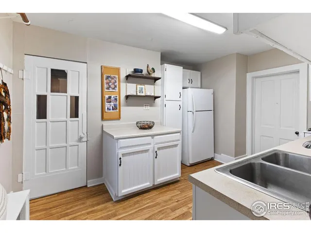 a kitchen with stainless steel appliances kitchen island granite countertop a refrigerator and a sink