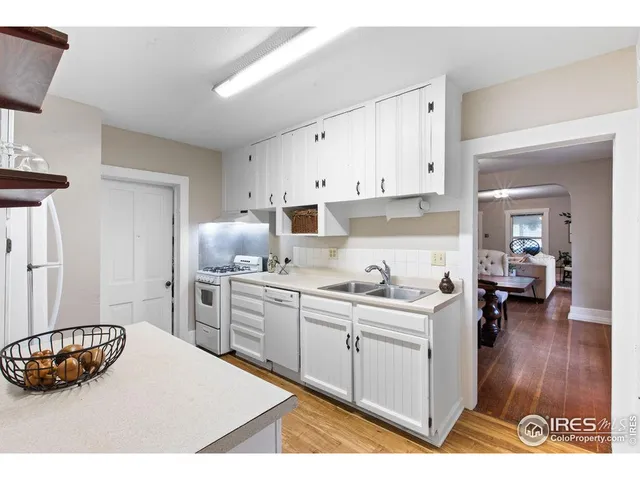 a kitchen with a sink a stove and cabinets