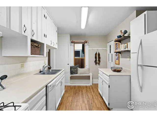 a kitchen with stainless steel appliances a stove a sink and a refrigerator