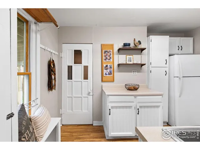 a kitchen with a refrigerator and cabinets