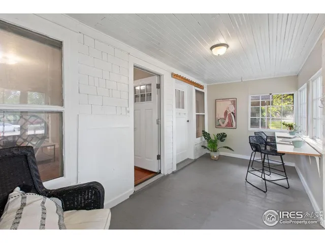 a living room with furniture rug and a window