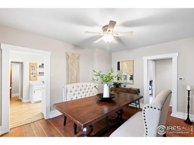 a living room with furniture a table and wooden floor