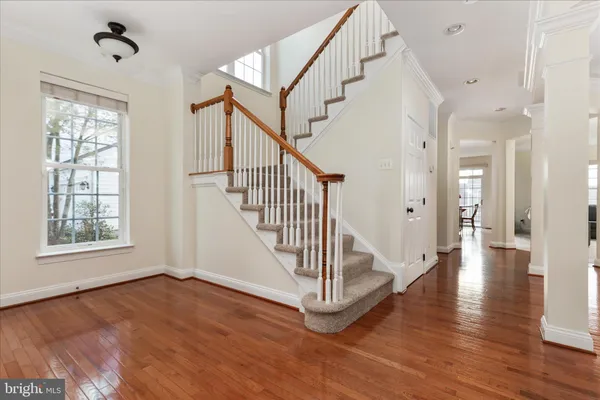 a view of an entryway with wooden floor and windows