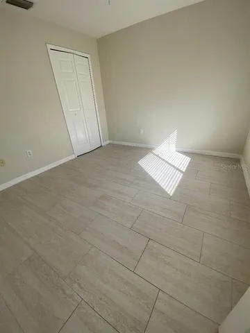 a view of an empty room and a window