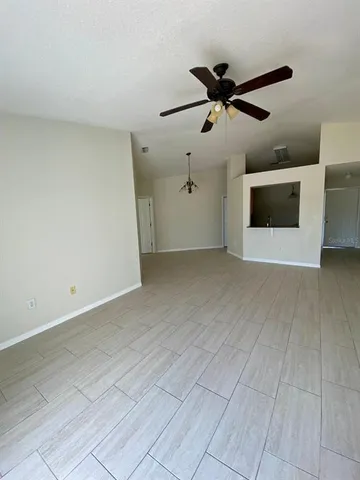 a view of an empty room with a ceiling fan