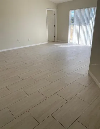 a view of an empty room and a window