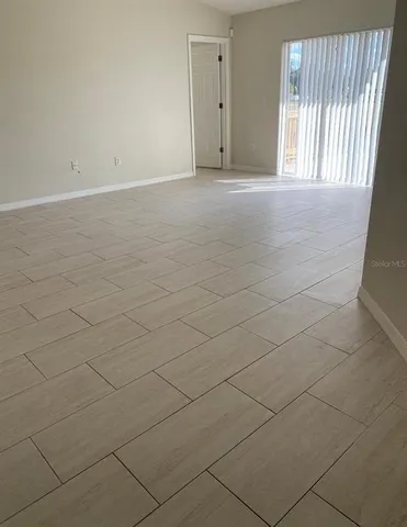a view of an empty room and a window