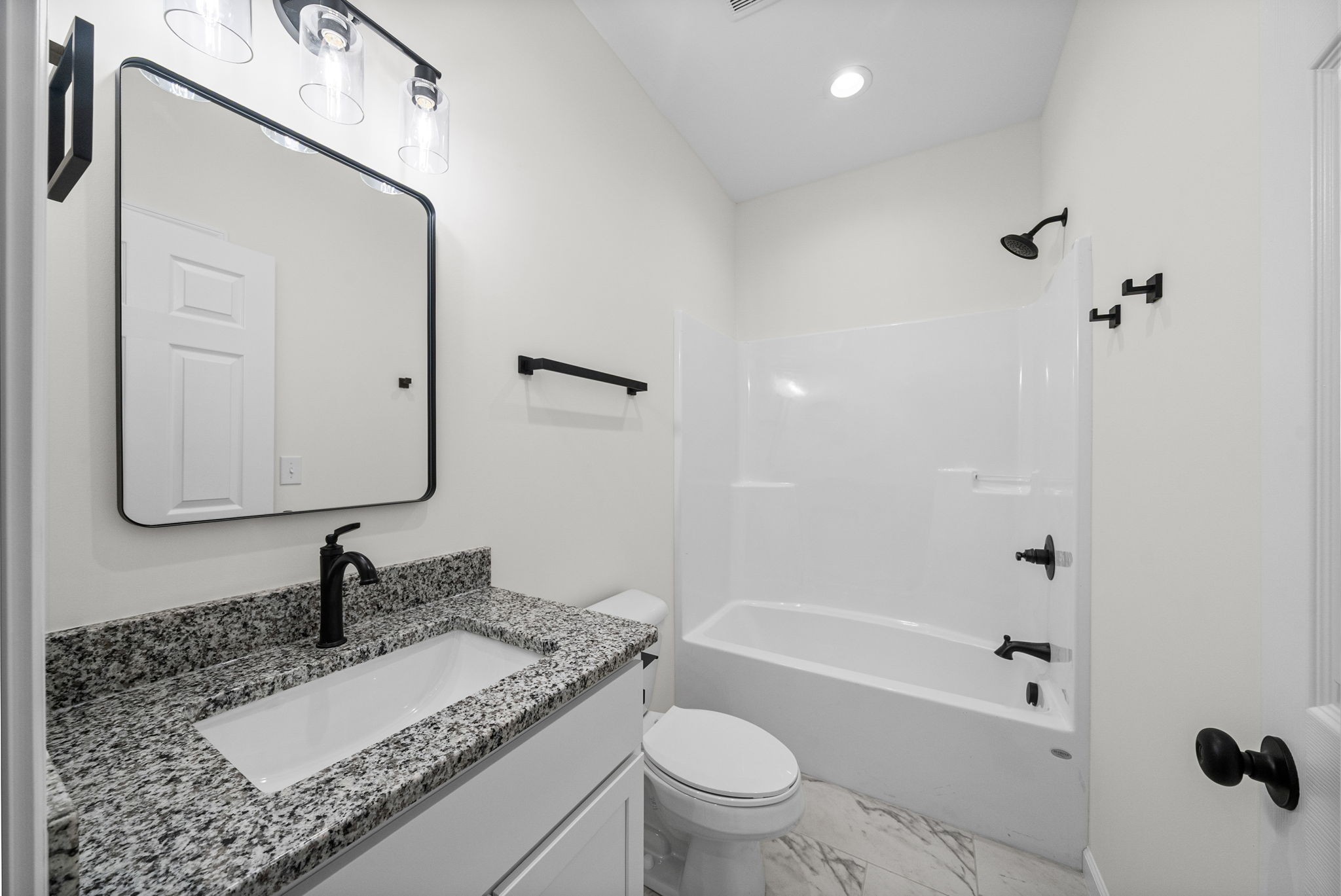 690 Brazzle Road Waverly, TN 37185 - Photo 24 of 35 a bathroom with a granite countertop sink a toilet and a mirror