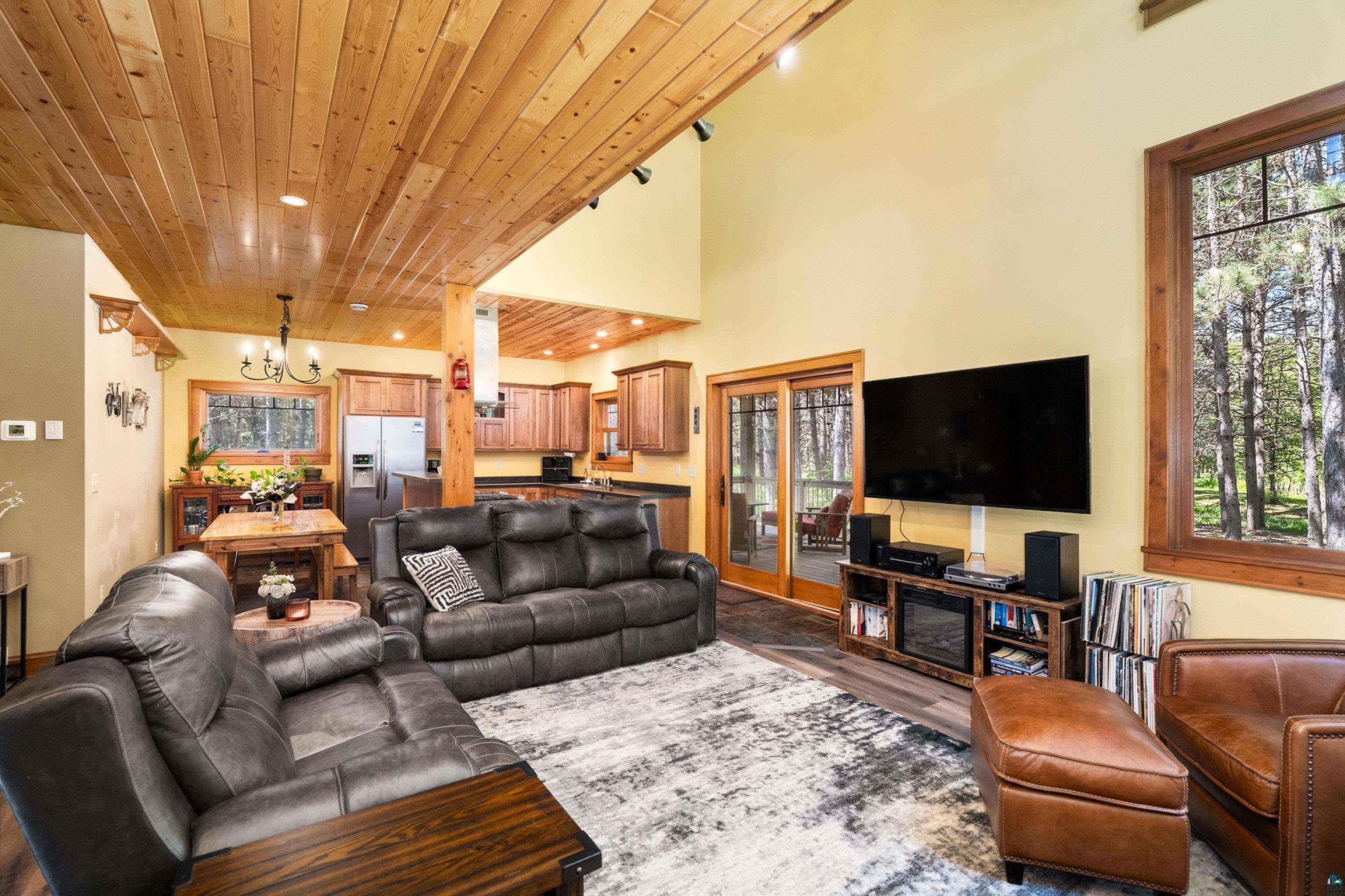 75 East Stark Road Esko, MN 55733 - Photo 13 of 87 Open-concept living space with a wood-planked ceiling, recessed lighting, and large windows with wood trim