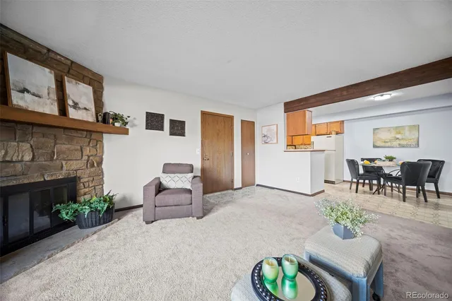 a living room with furniture a fireplace and a table