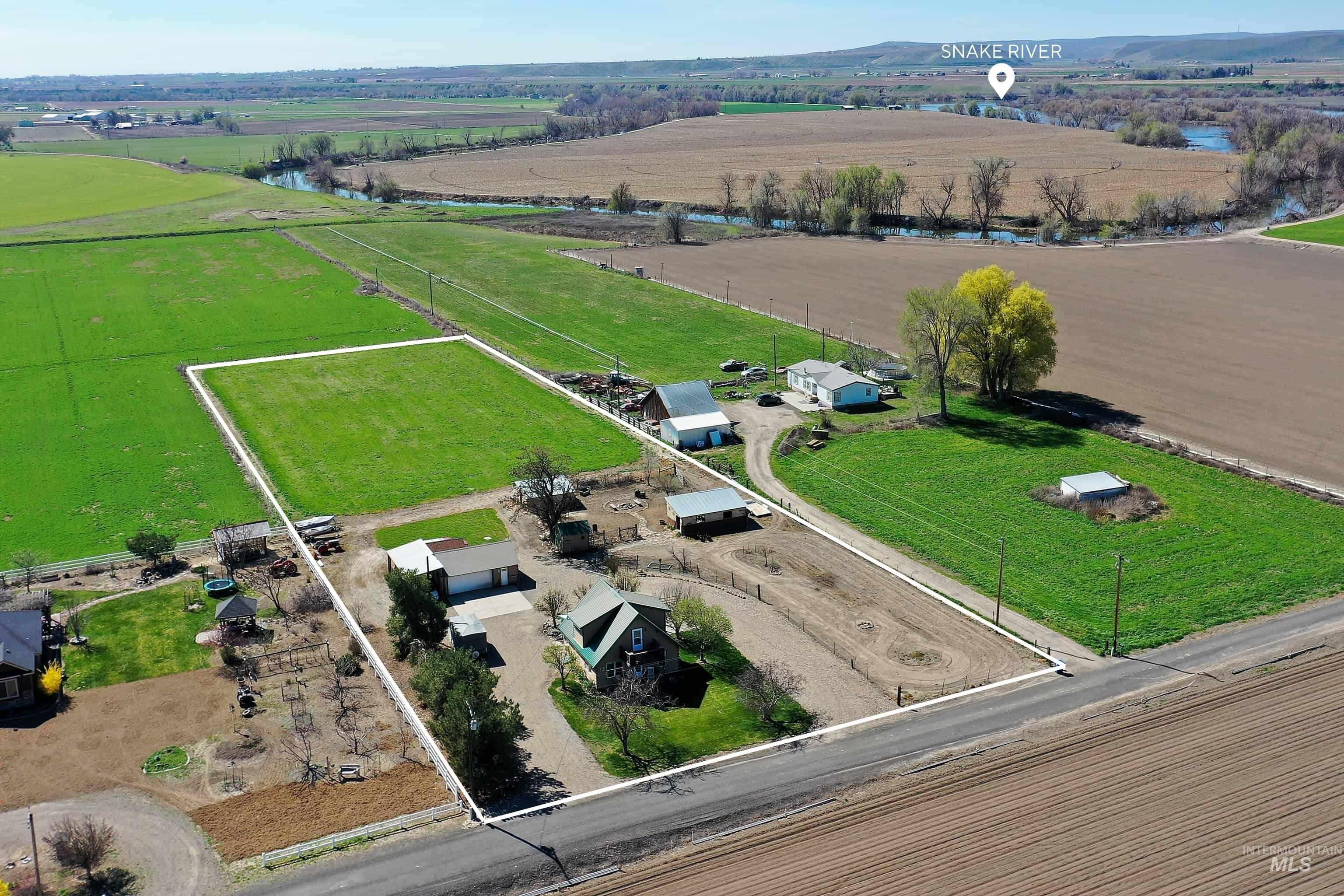 Aerial view of sparsely populated area featuring property boundaries highlighted