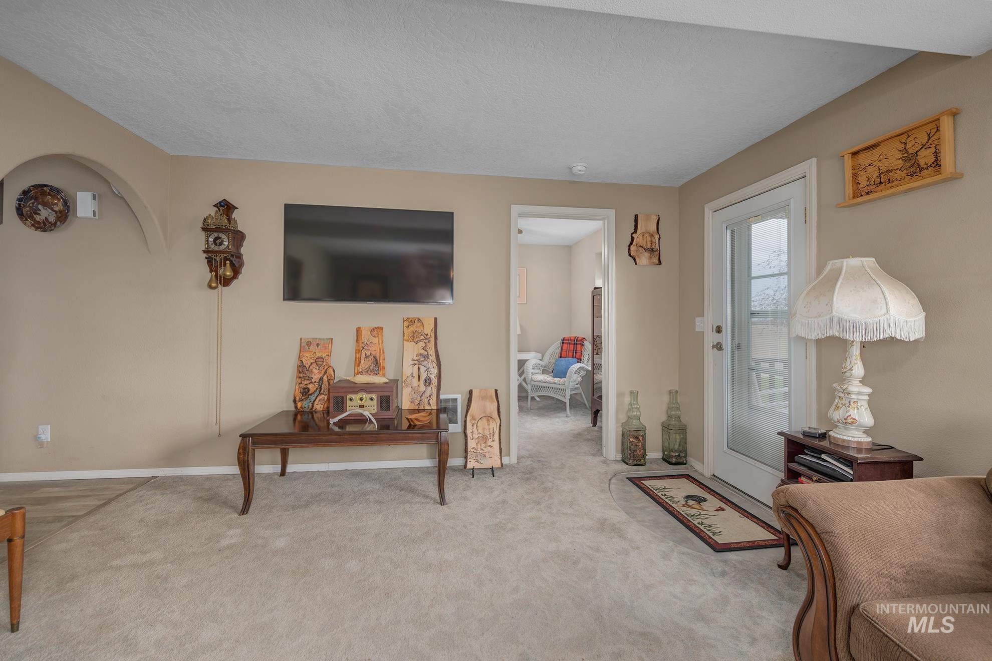 1363 Ross Road Weiser, ID 83672 - Photo 12 of 47 Living area with carpet floors and a textured ceiling
