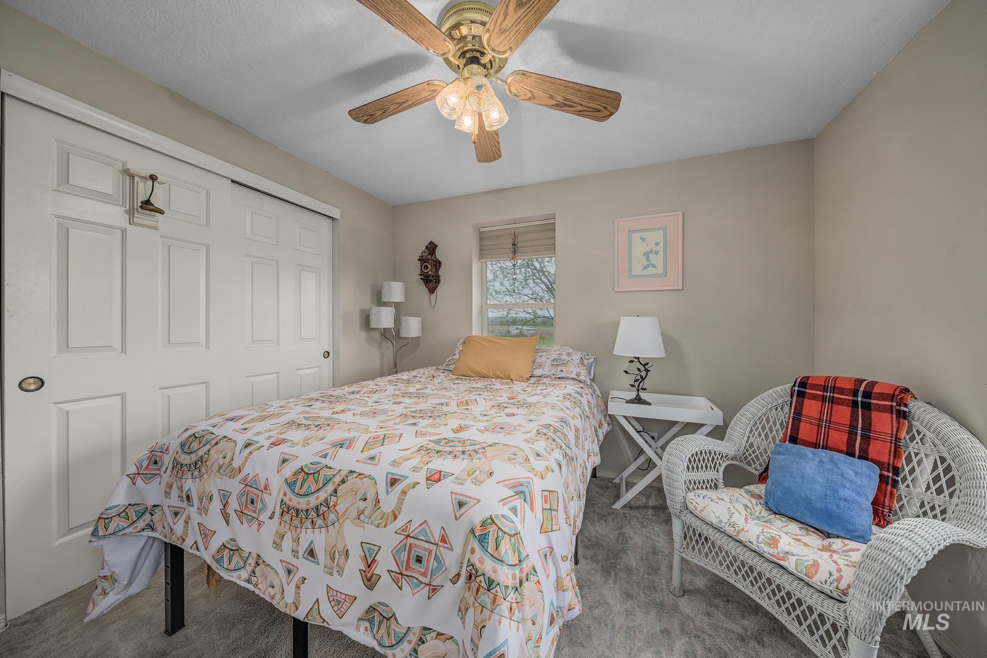 1363 Ross Road Weiser, ID 83672 - Photo 13 of 47 Bedroom featuring a closet, carpet flooring, and ceiling fan