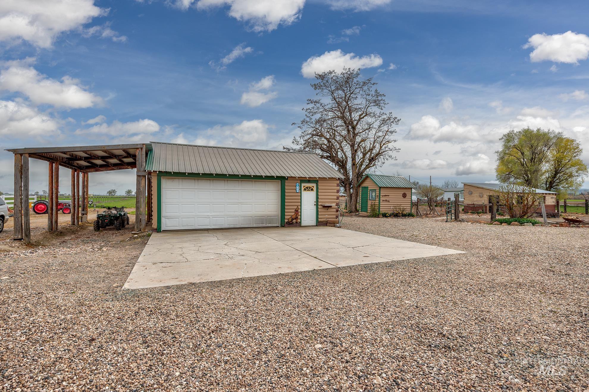 1363 Ross Road Weiser, ID 83672 - Photo 24 of 47 View of front of home featuring an outdoor structure, a garage, and a metal roof