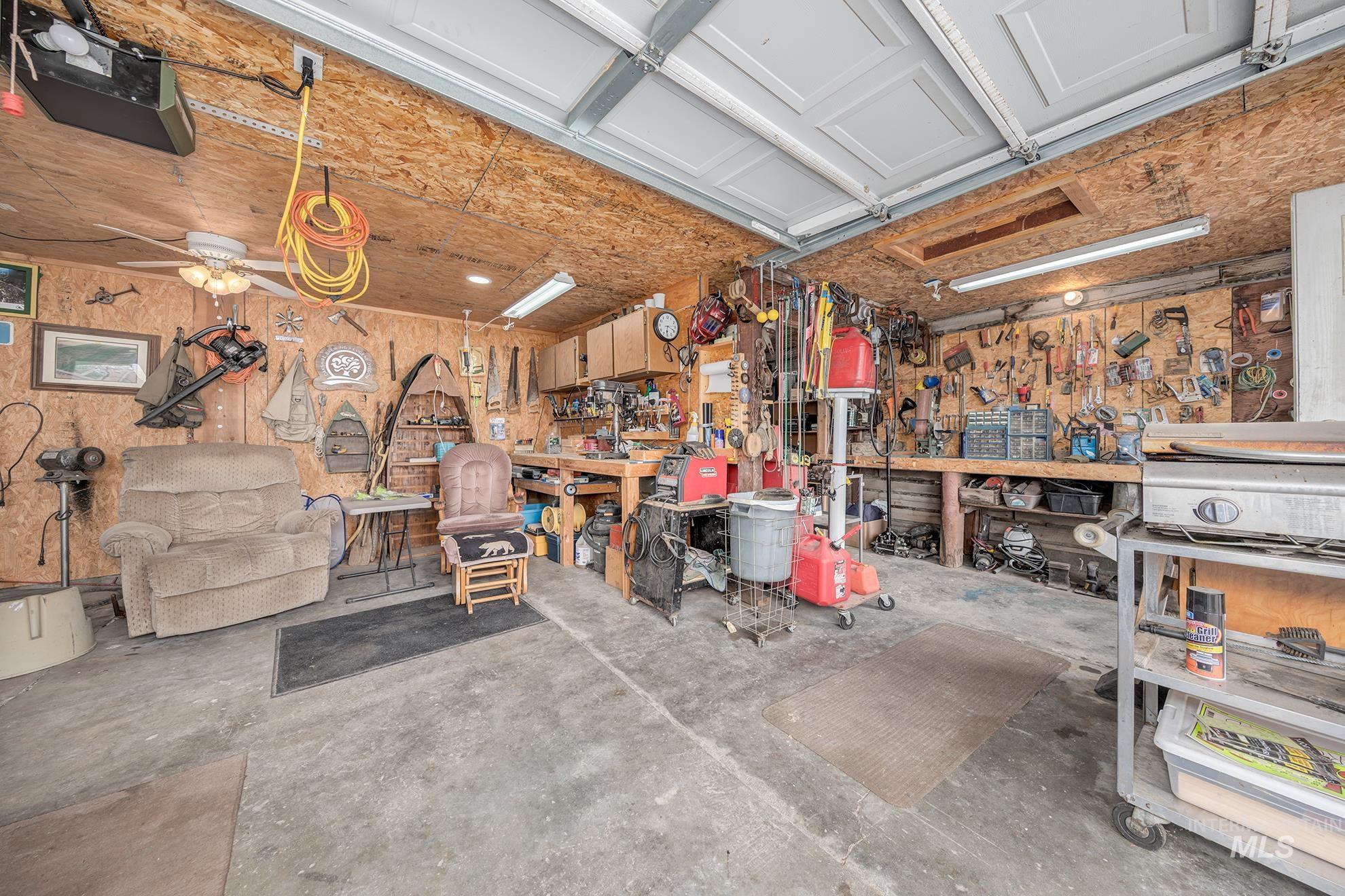 1363 Ross Road Weiser, ID 83672 - Photo 26 of 47 Garage featuring a workshop area, a ceiling fan, and a garage door opener