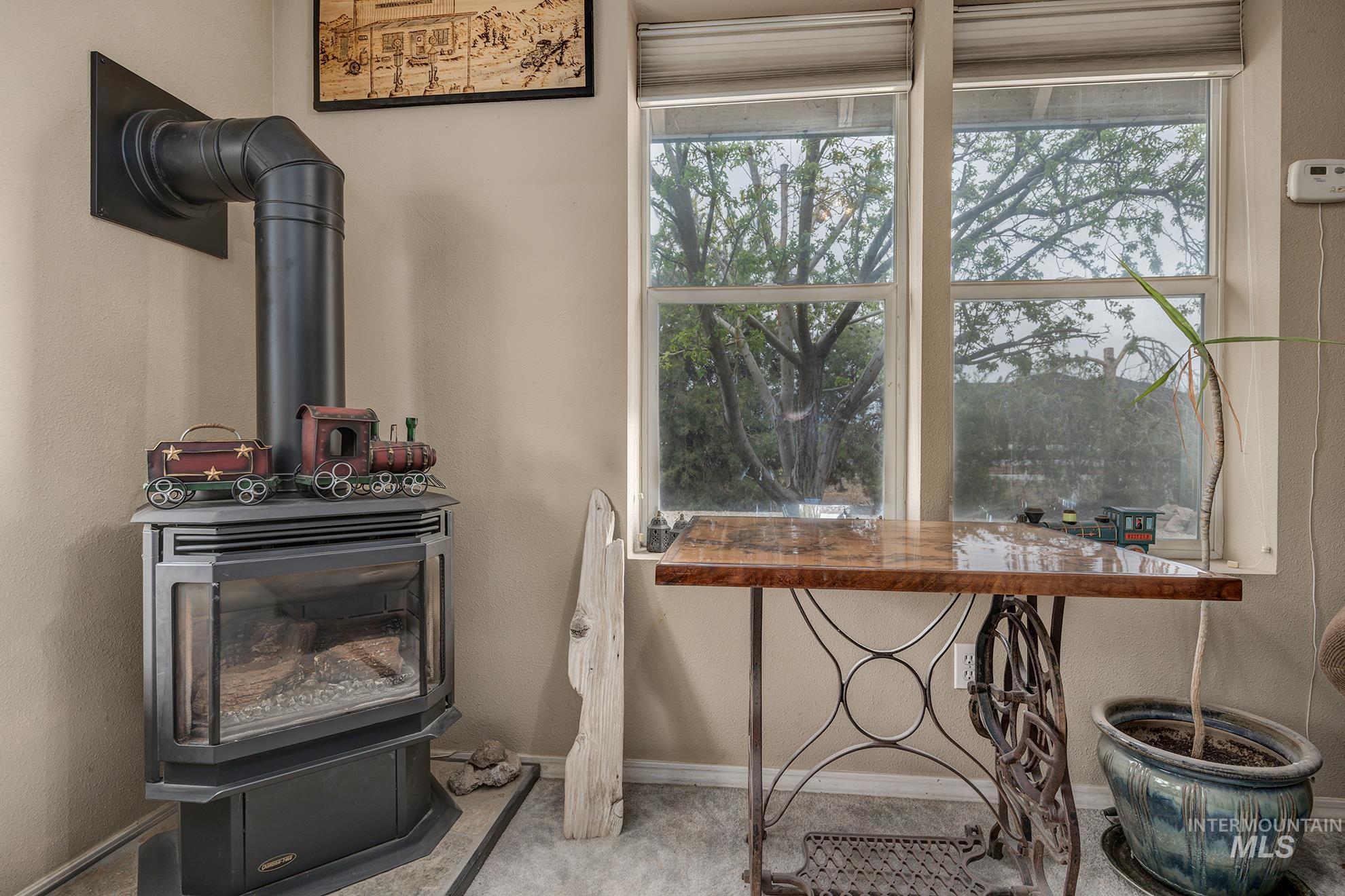 1363 Ross Road Weiser, ID 83672 - Photo 6 of 47 Detailed view of a wood stove and a textured wall