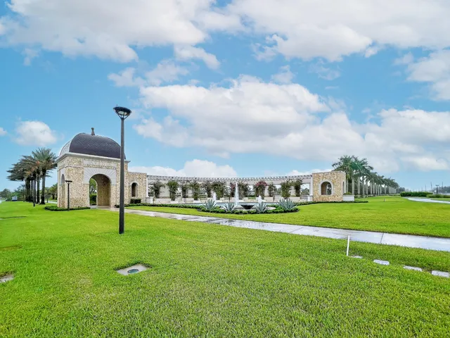 a view of a big house with a big yard and a large trees