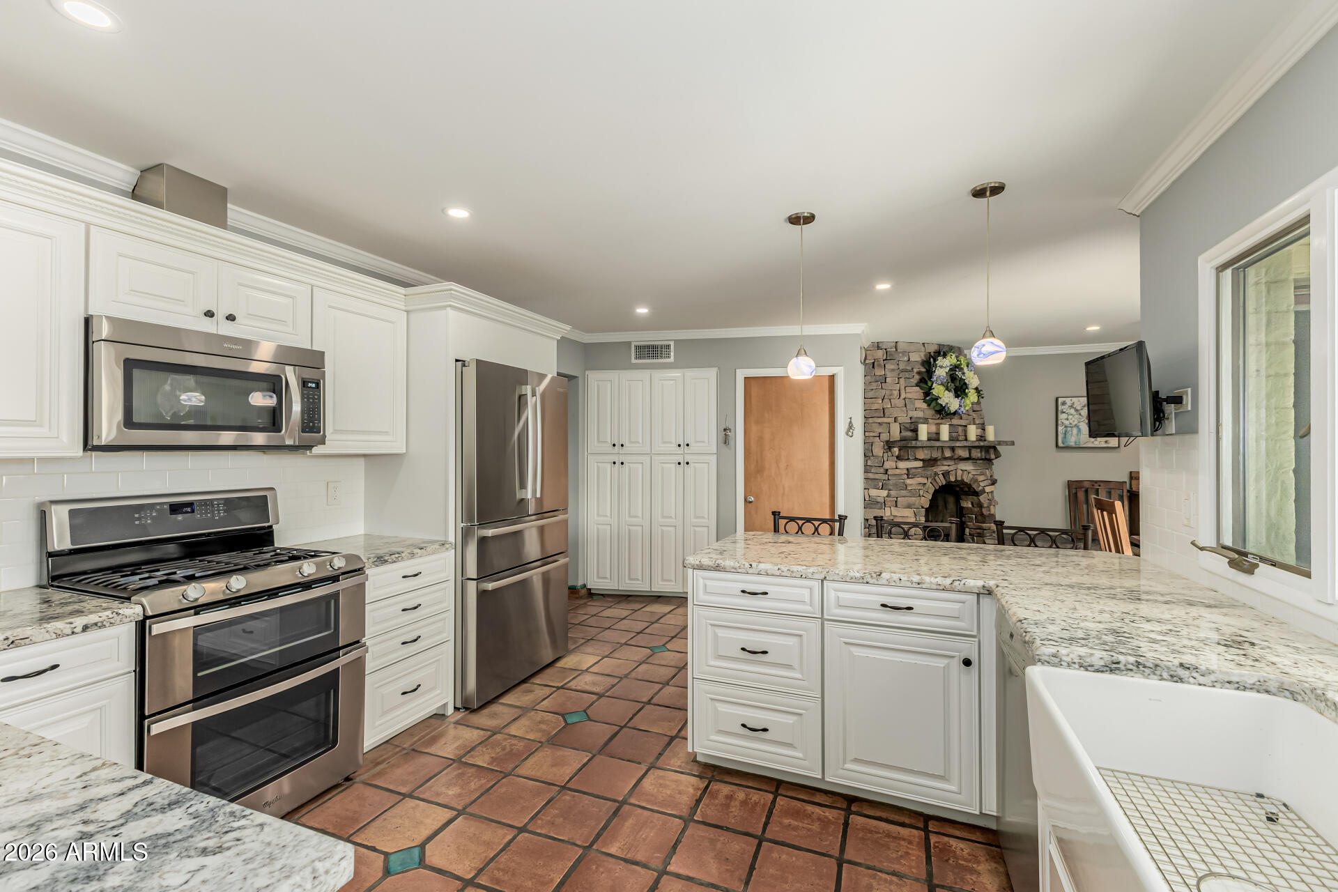 1003 East Watson Drive Tempe, AZ 85283 - Photo 14 of 39 a kitchen with stainless steel appliances kitchen island granite countertop a stove and a sink