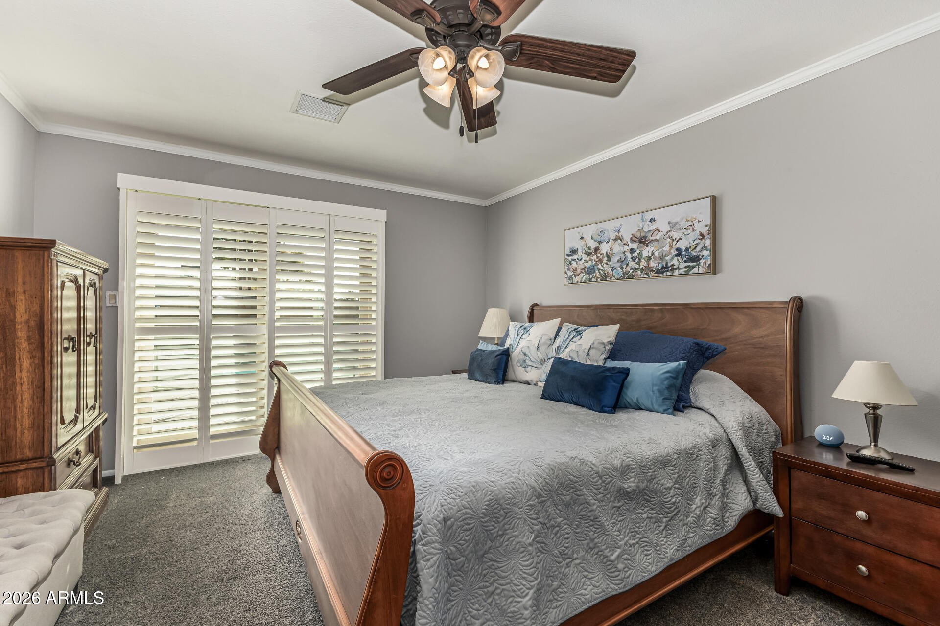 1003 East Watson Drive Tempe, AZ 85283 - Photo 16 of 39 a bedroom with a large bed and a chandelier