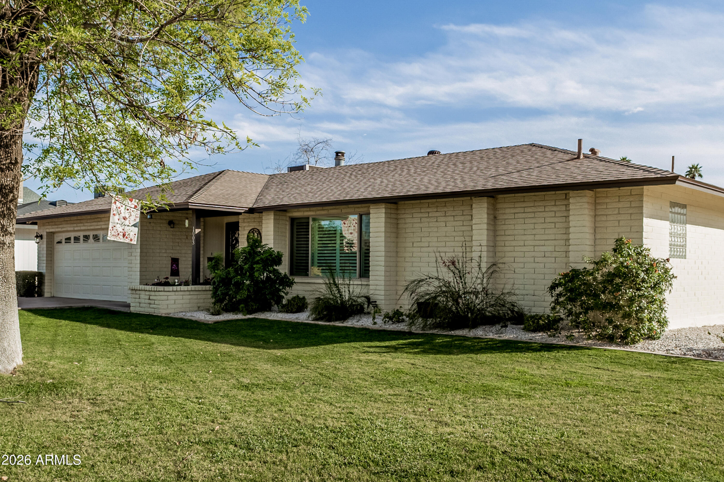 1003 East Watson Drive Tempe, AZ 85283 - Photo 2 of 39 a front view of a house with garden