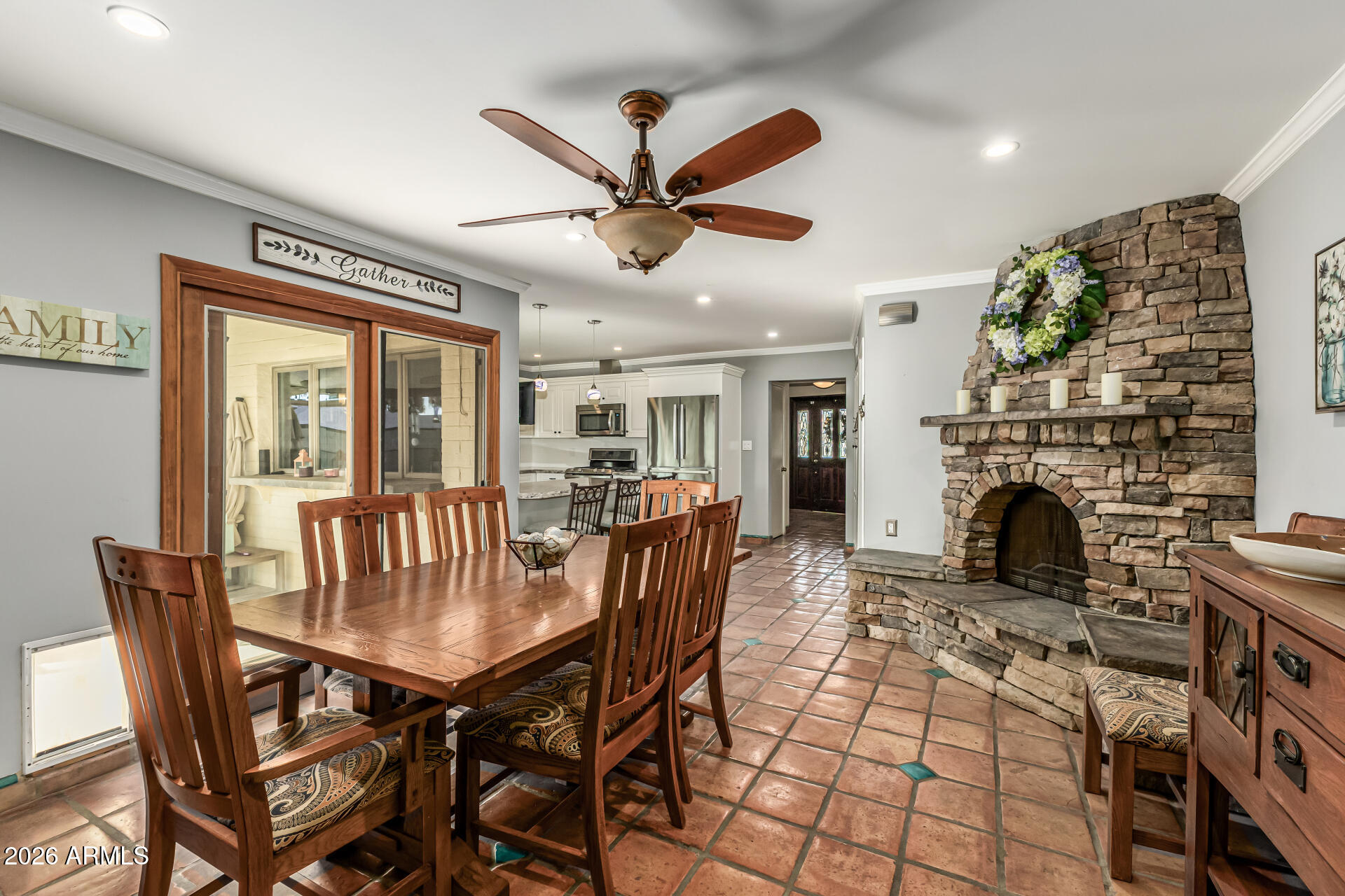 1003 East Watson Drive Tempe, AZ 85283 - Photo 8 of 39 a dining room with furniture a fireplace and a chandelier