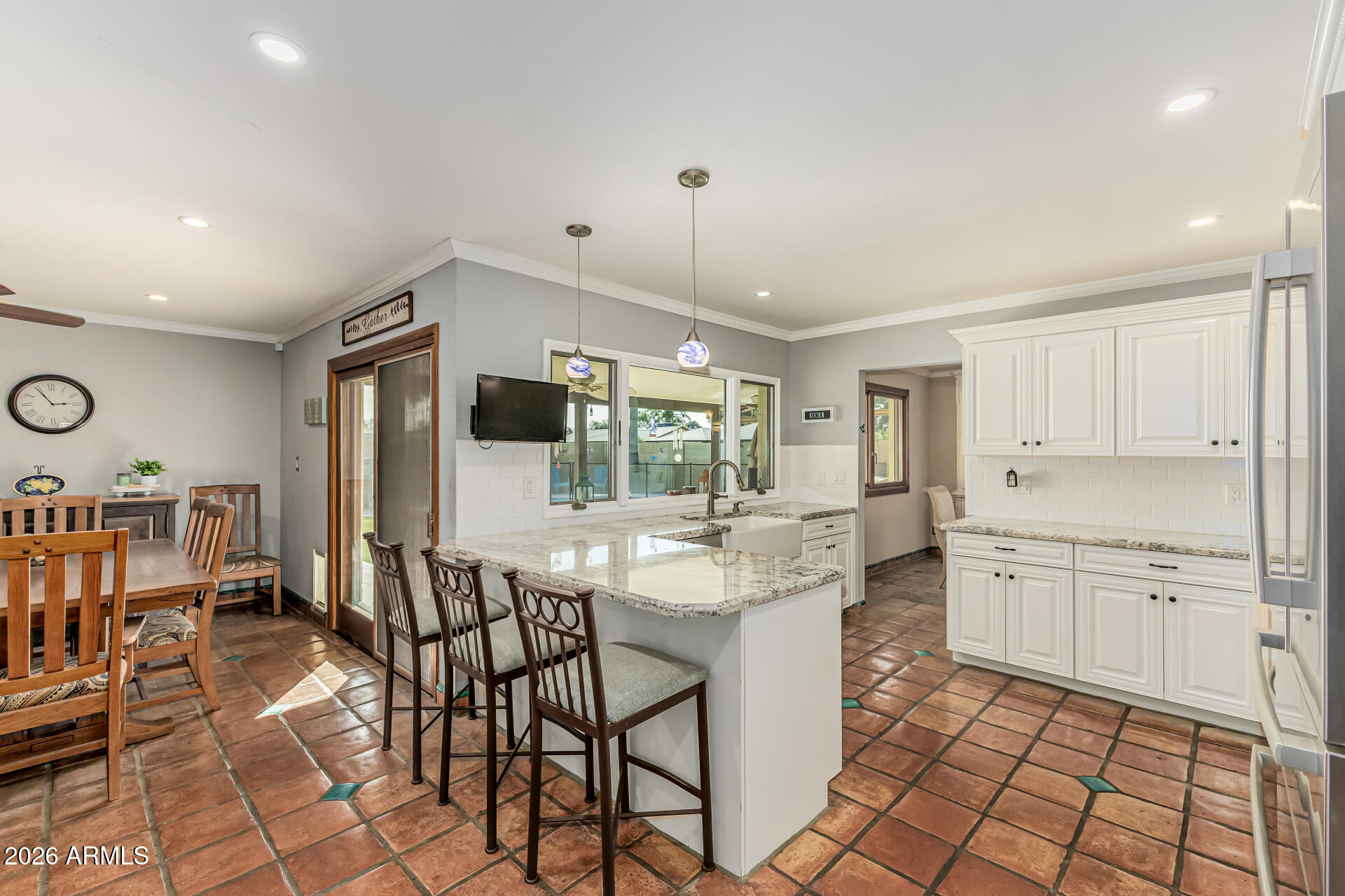 1003 East Watson Drive Tempe, AZ 85283 - Photo 10 of 39 a kitchen with stainless steel appliances granite countertop a stove top oven a sink dishwasher and white cabinets with wooden floor