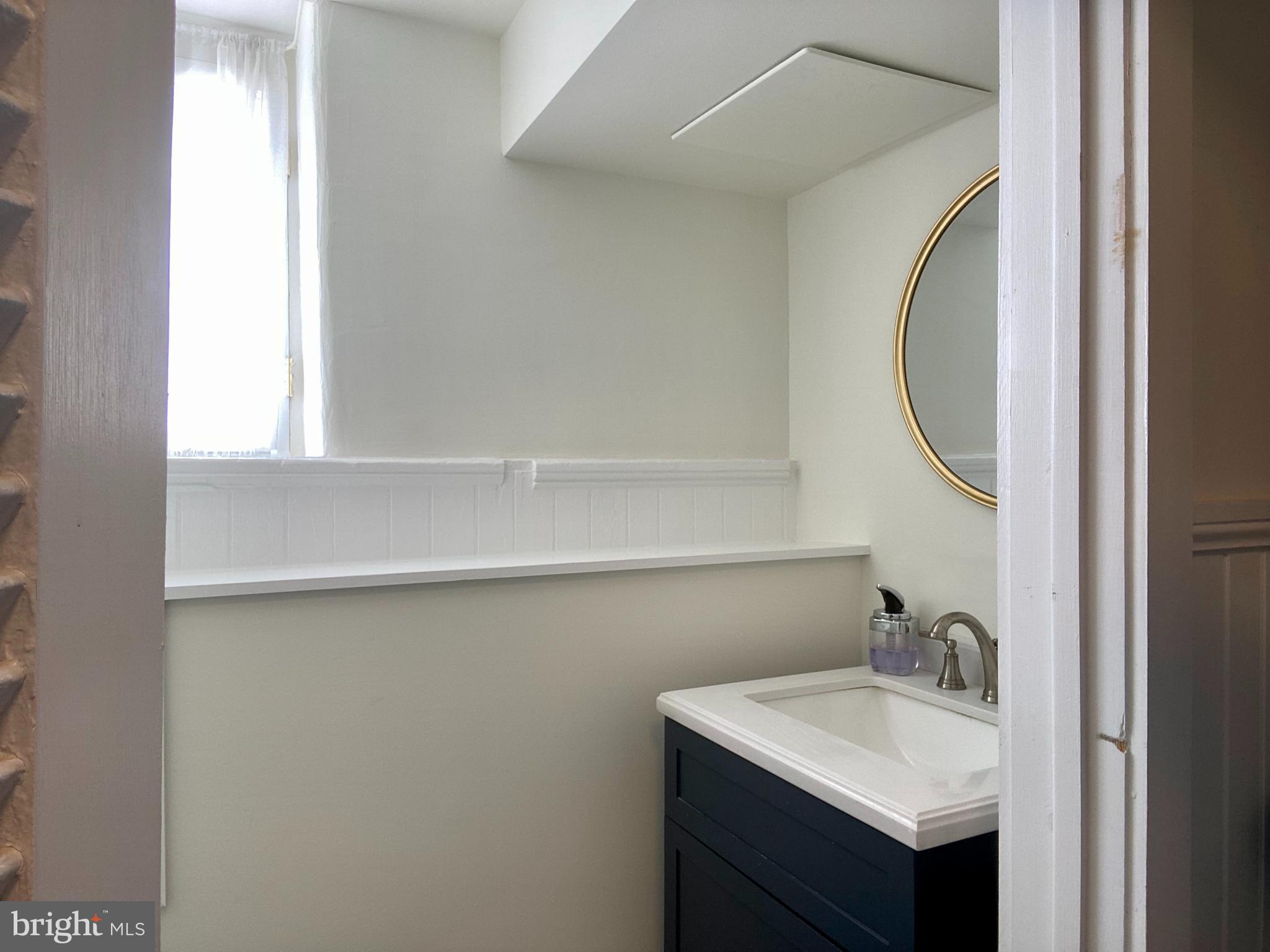 121 Upnor Road Baltimore, MD 21212 - Photo 73 of 79 a bathroom with a sink and a mirror