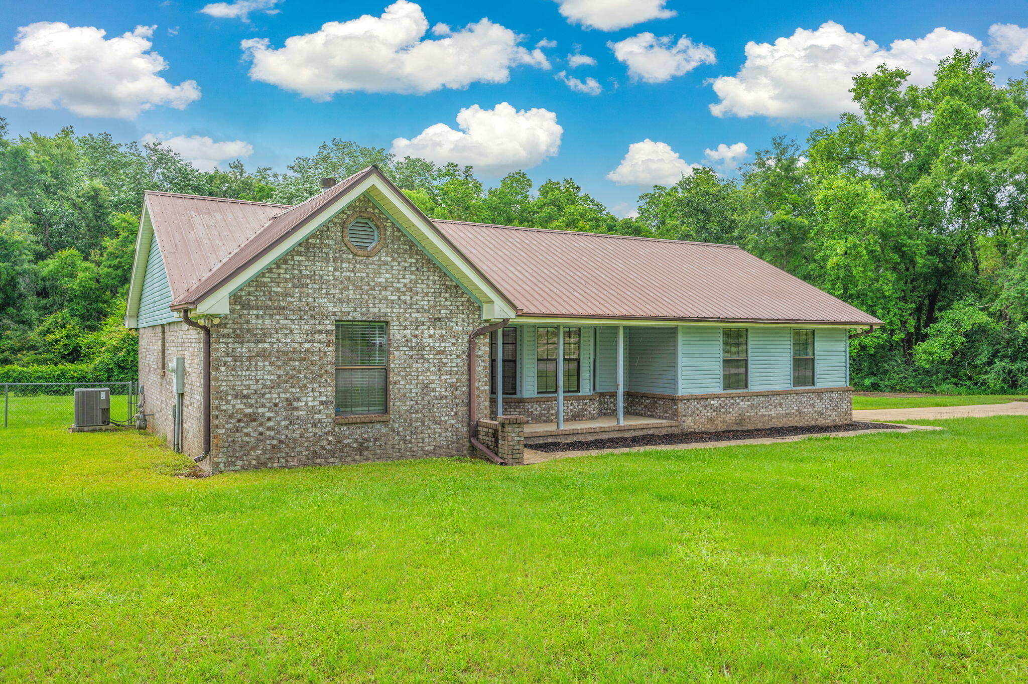 5903 Jack Stokes Road Baker, FL 32531 - Photo 1 of 35 a view of a house with a yard potted plants and large tree