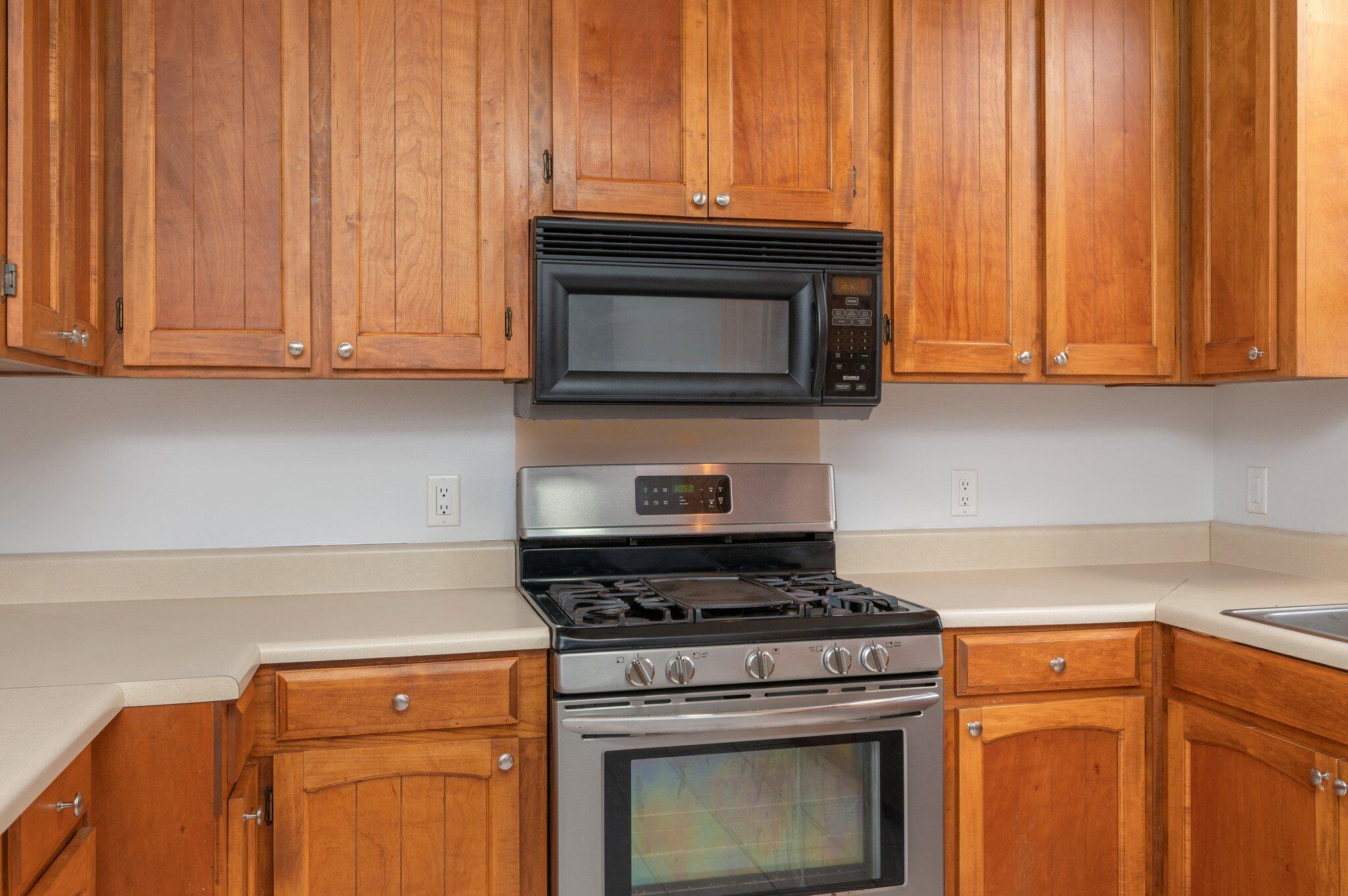 5903 Jack Stokes Road Baker, FL 32531 - Photo 12 of 35 a kitchen with granite countertop wood cabinets and a stove top oven