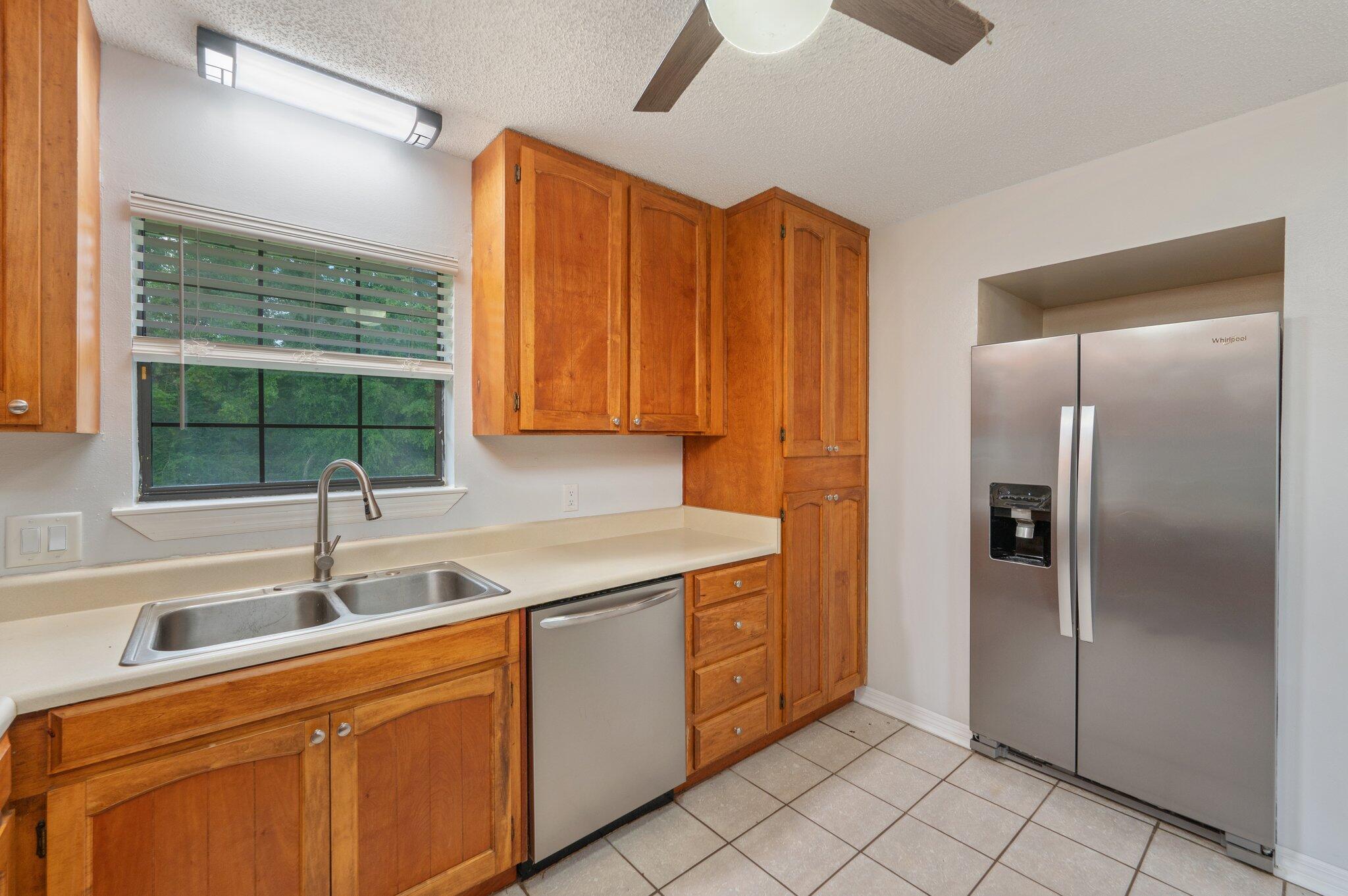 5903 Jack Stokes Road Baker, FL 32531 - Photo 15 of 35 a kitchen with stainless steel appliances granite countertop a refrigerator and a sink