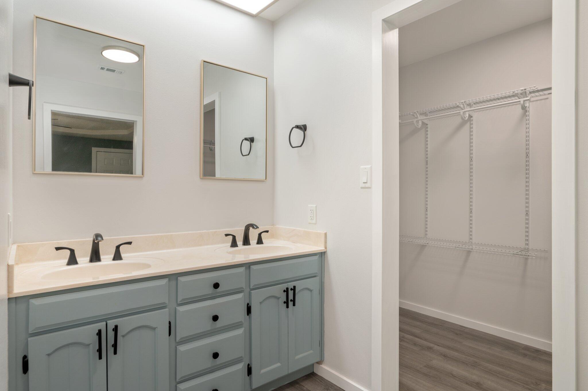 5903 Jack Stokes Road Baker, FL 32531 - Photo 20 of 35 a bathroom with a double vanity sink and mirror