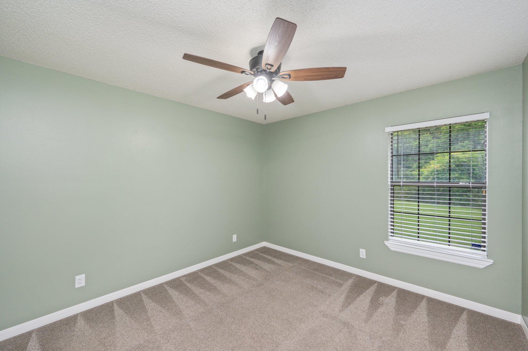 5903 Jack Stokes Road Baker, FL 32531 - Photo 25 of 35 an empty room with a window and a fan