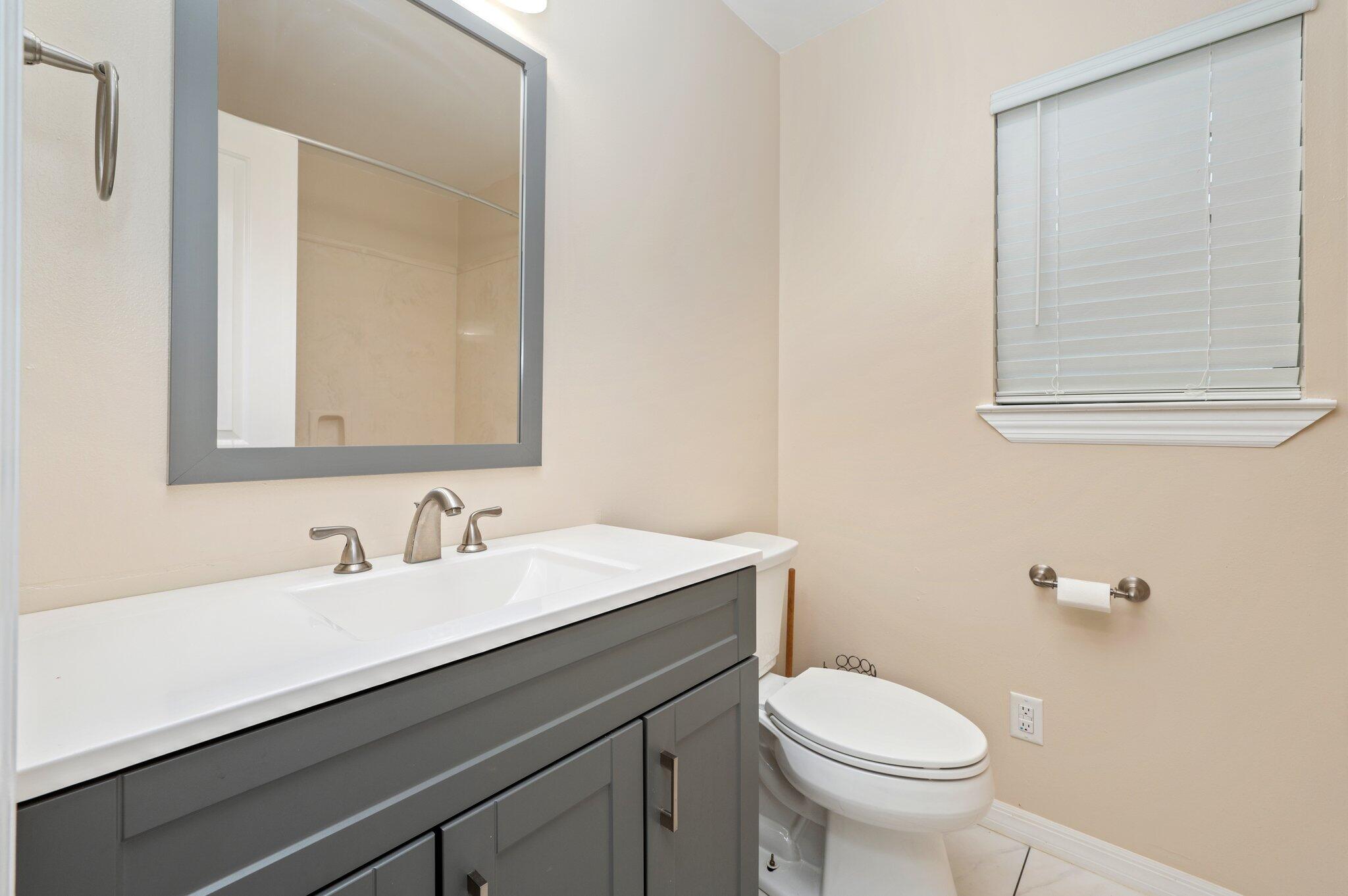 5903 Jack Stokes Road Baker, FL 32531 - Photo 27 of 35 a bathroom with a sink a toilet and mirror