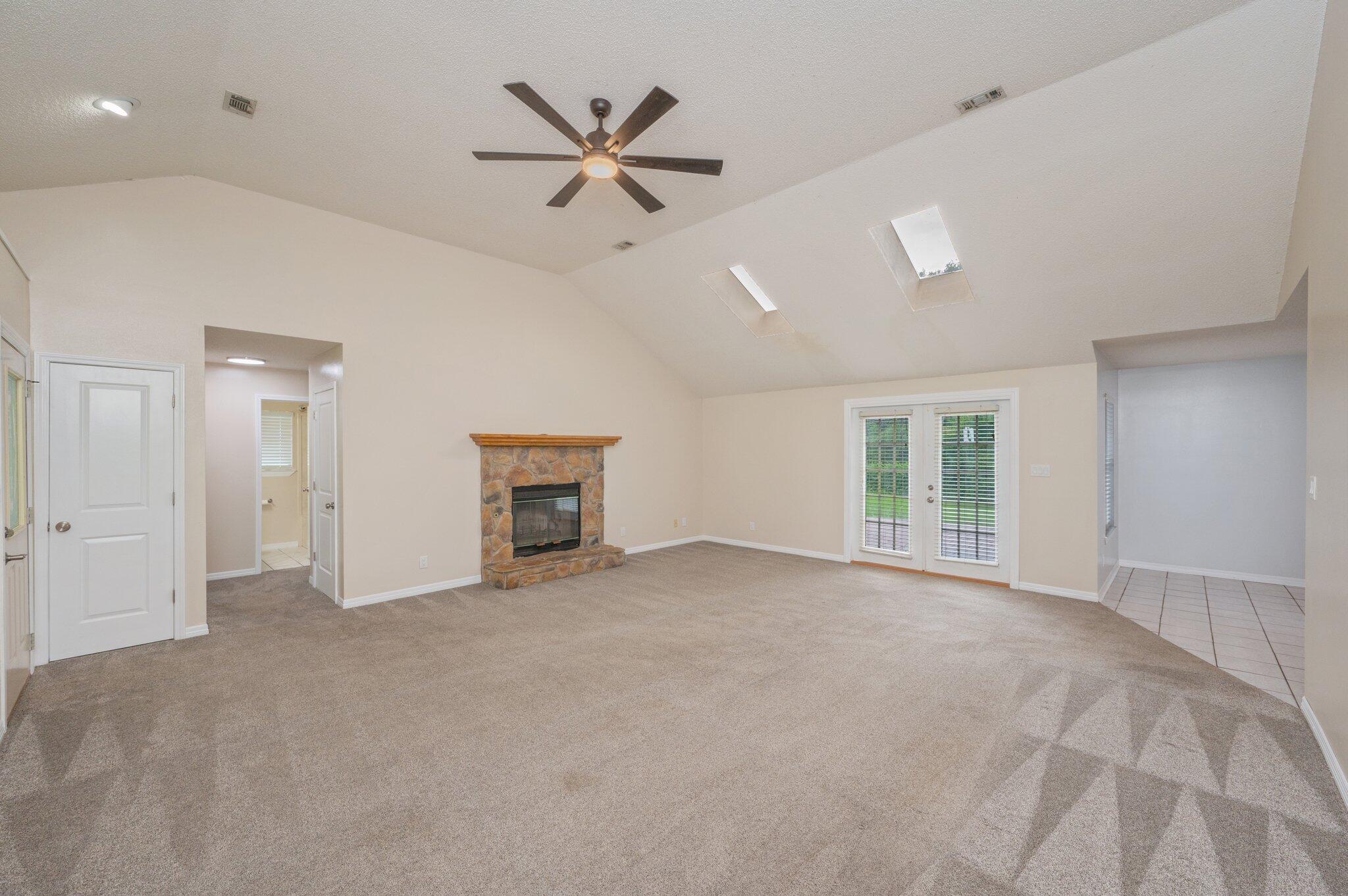 5903 Jack Stokes Road Baker, FL 32531 - Photo 6 of 35 an empty room with windows and ceiling fan