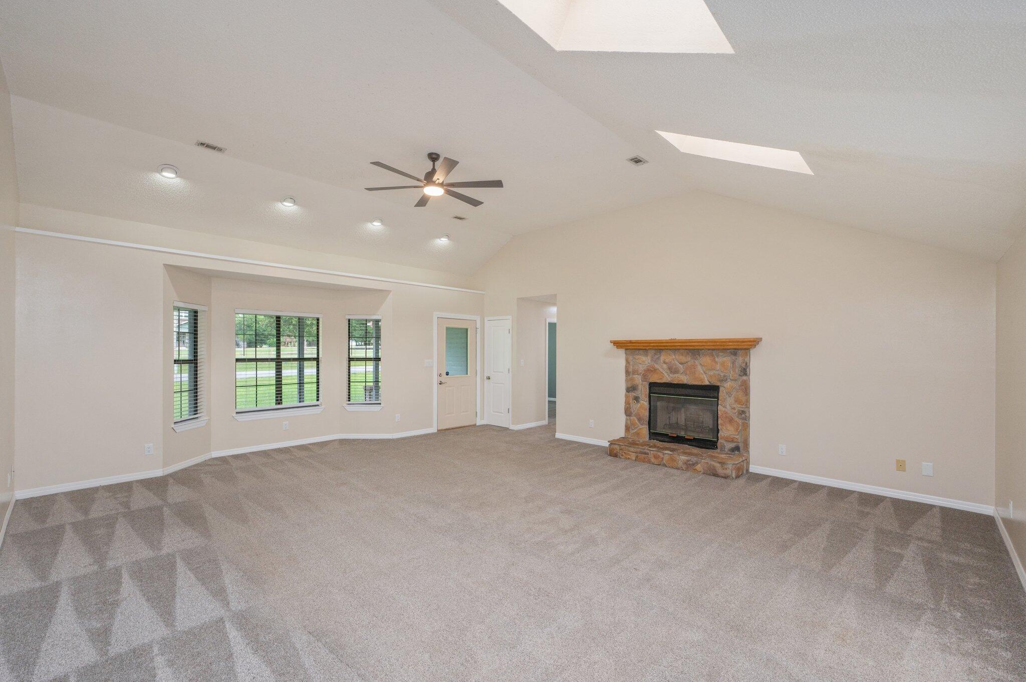 5903 Jack Stokes Road Baker, FL 32531 - Photo 7 of 35 an empty room with windows and ceiling fan