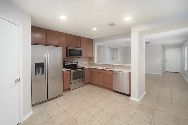 a kitchen with a refrigerator sink and microwave