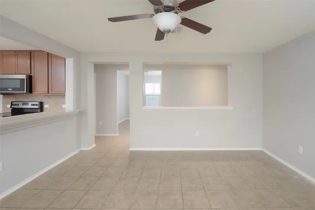 a view of a kitchen with a sink cabinets and stainless steel appliances