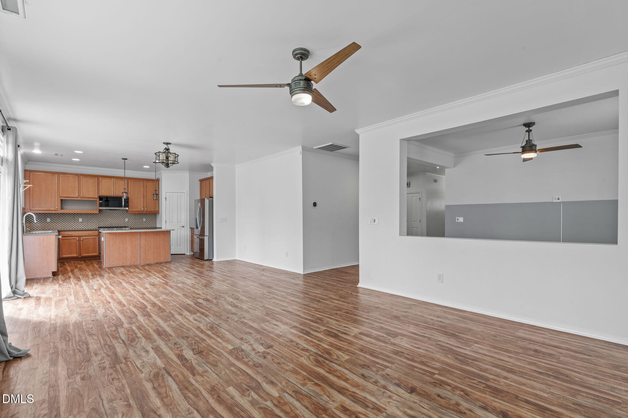 124 Daneborg Road Durham, NC 27703 - Photo 24 of 40 a view of open kitchen with wooden floor and a ceiling fan